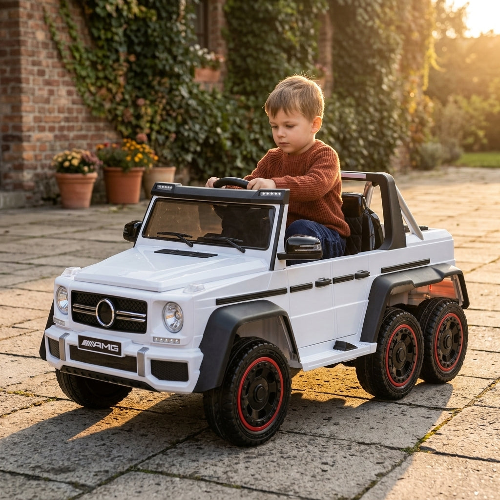 Džip na akumulator beli Mercedes 6x6 u dvorištu tokom zlatnog popodnevnog sunca